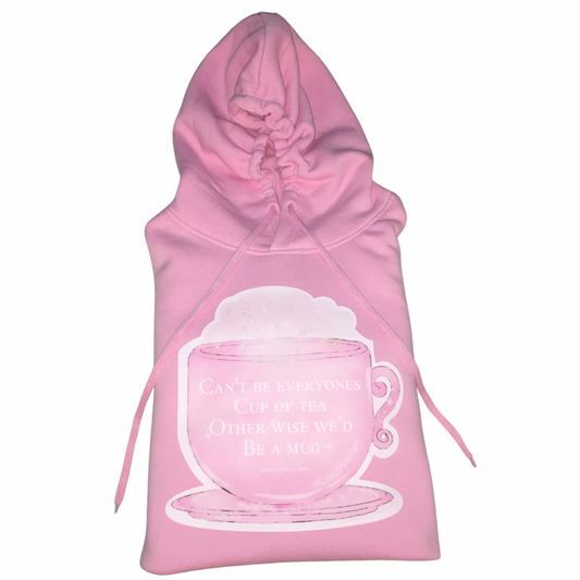 Single flat lay view of a pink cotton oversized hoodie highlighting the large cup of tea chest graphic design and long tie pull strings.