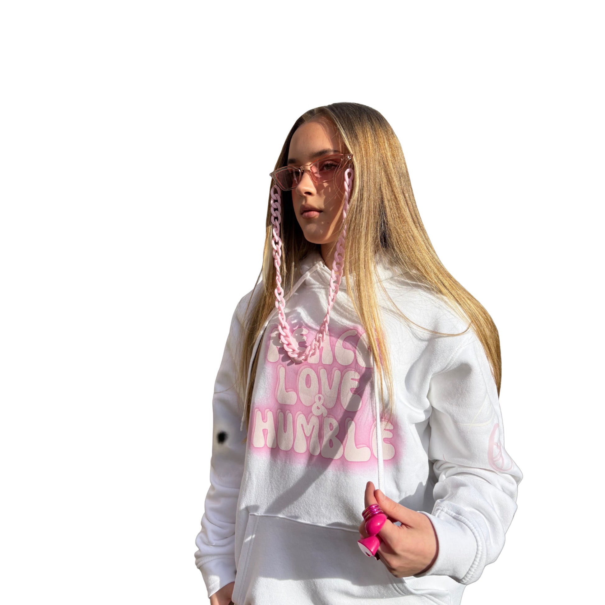 Angled side profile of a model wearing a white festival hoodie with pink graphic text, showing the clean drape of the oversized silhouette.