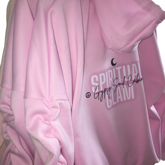 Close-up back view of a pink scrunched sleeve hoodie highlighting the Gypsy Soul Cabin logo and 'Spiritual But Glam' text layout printed near the shoulder.