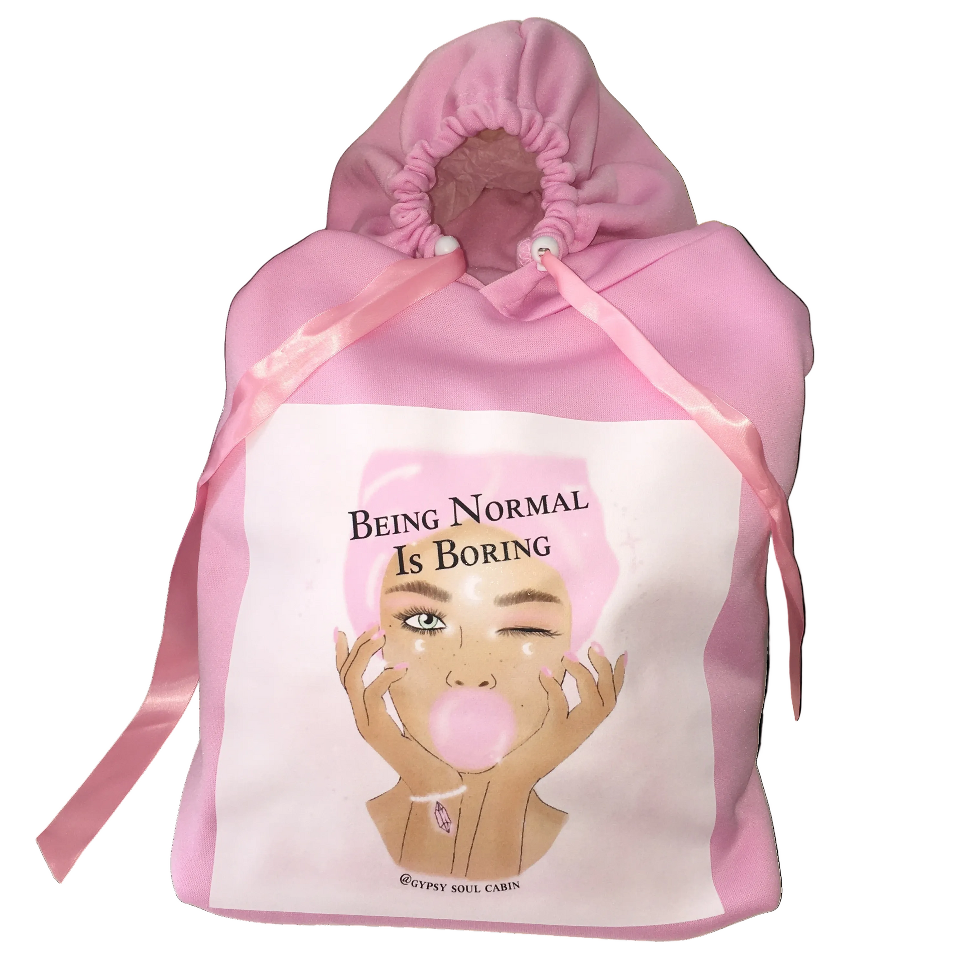 Front studio layout view of a pink one-size polyester hoodie featuring scrunched sleeve edges, thick pink satin tie ribbons, and a central 'Being Normal Is Boring' winking bubblegum girl graphic art print.
