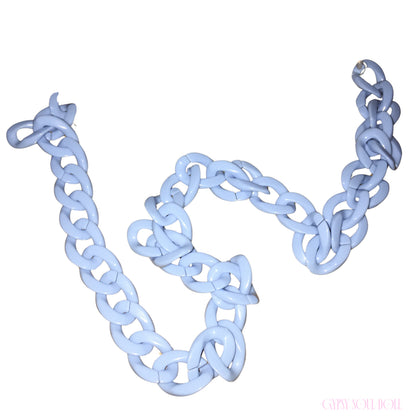 A chunky light blue chain glasses lanyard with oversized interlocking links, arranged in a loose spiral on a plain white background.