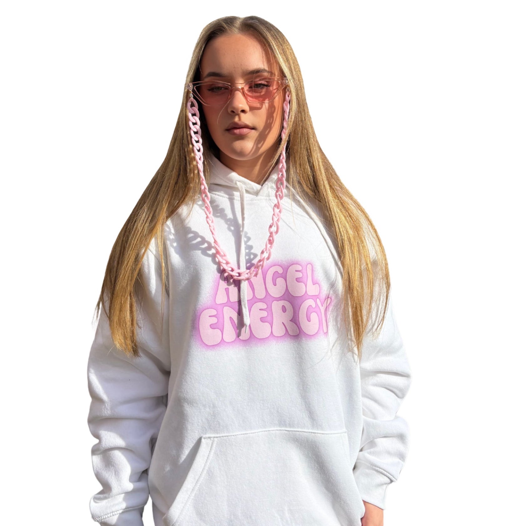 Front view of a white oversized pullover hoodie featuring a vibrant purple Angel Energy graphic text design across the front chest, styled perfectly for a high-vibe festival look.