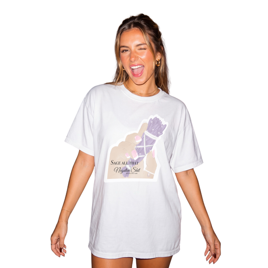 Model winking and showcasing the archive white cotton Gypsy Soul Cabin T-shirt featuring a purple sage bundle graphic reading Sage All That Negative Shit.
