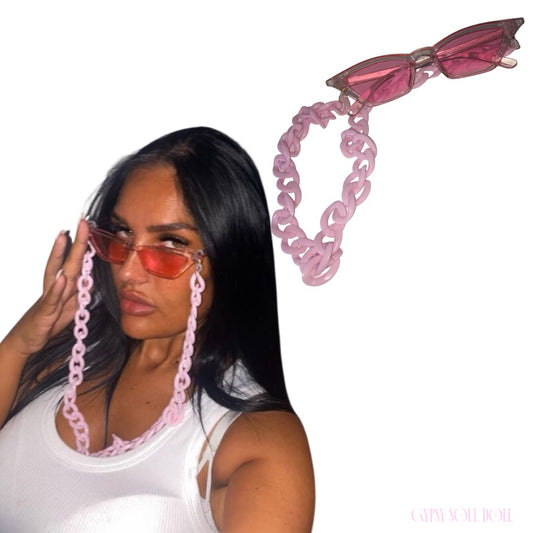Model showcasing the Gypsy Soul Doll Saint Tropez translucent pink cat eye sunglasses with a matching thick pastel pink acrylic link lanyard strap chain against a plain white background.