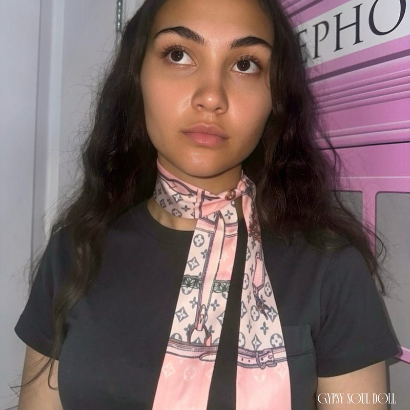 Model showcasing the Gypsy Soul Doll pink monogram skinny satin scarf wrapped elegantly as a multi-way neck tie choker styled with a black T-shirt.