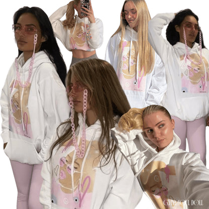 A collage of models wearing a white oversized hoodie with a front pocket and tie pull strings, featuring pink and purple spiritual-themed graphics and text on the front that reads limited edition.