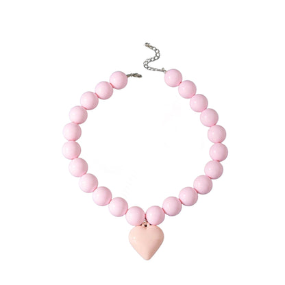 Studio product shot of the Gypsy Soul Doll pink chunky bubblegum resin bead necklace with a large matching pastel pink puffy heart pendant, showing its silver lobster clasp and adjustable metal chain extender against a plain white background.