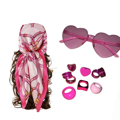 A collection layout from Gypsy Soul Doll displaying a pink silk printed hair bandana scarf on long curly hair, alongside frameless pink heart sunglasses and a matching stack of seven chunky acrylic resin rings on a white background.