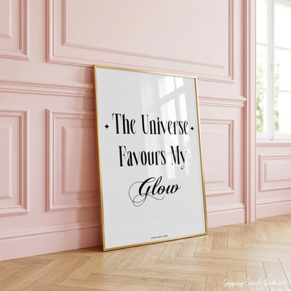 Independent girl-boss typography quote poster displaying the text "The Universe Favours My Glow" with small sparkle star icons and cursive accents.