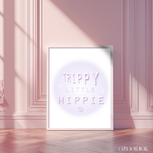 Retro Trippy Little Hippie typography art print featuring a soft purple gradient aura design in a white frame, styled against a chic pastel pink paneled wall.