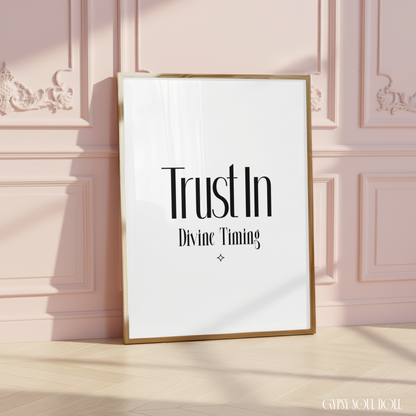 Minimalist spiritual wall art print reading "Trust In Divine Timing," centred on a crisp background with a small matching protective diamond emblem.