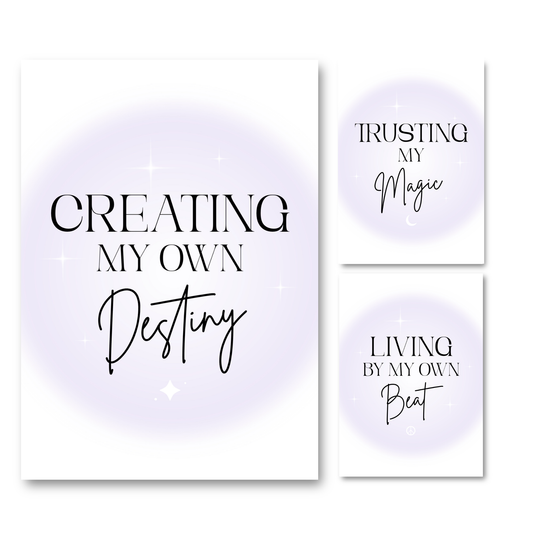 Three vertical wall art prints with inspirational typography on a white background. The left print reads 'CREATING MY OWN Destiny' and the right prints read 'TRUSTING MY Magic' and 'LIVING BY MY OWN Beat'.