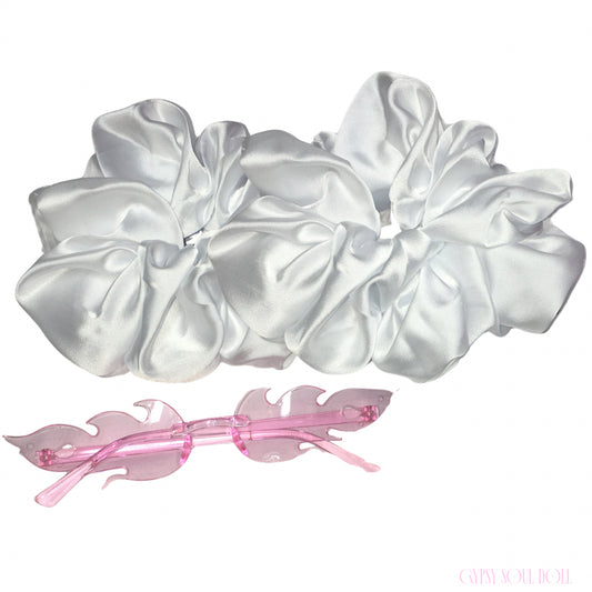 A set of two large white satin hair scrunchies and a translucent pink plastic hair clip, displayed on a clean white background.
