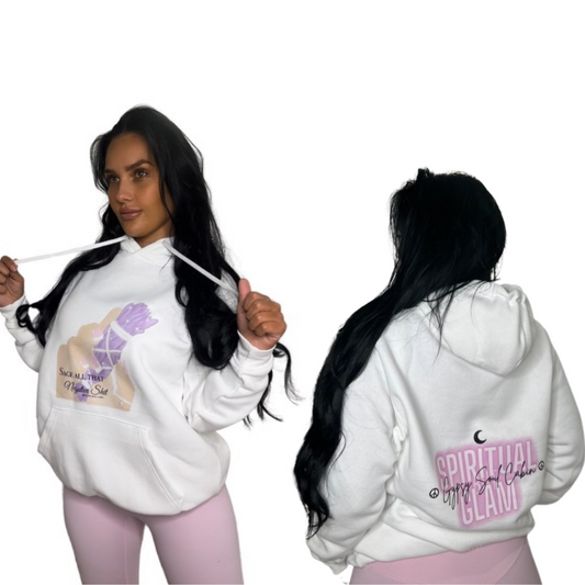 A woman modeling a white pullover hoodie shown from both front and back views against a plain white background. The front features a graphic with a hand holding a large sage and the text 'Sage all that negative shit', while the back displays a pink graphic reading 'SPIRITUAL BUT GLAM' with a small black crescent moon above it.